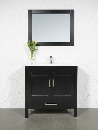 Black vanity, white ceramic sink, black framed mirror