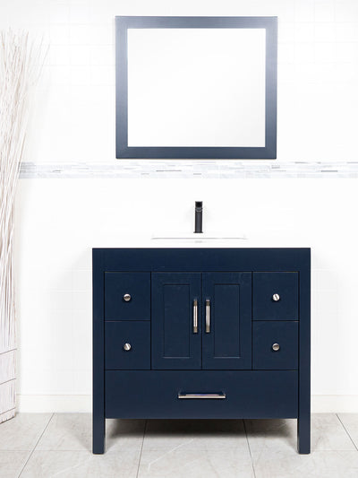 Blue bathroom vanity, white counter, wood framed mirror, black faucet