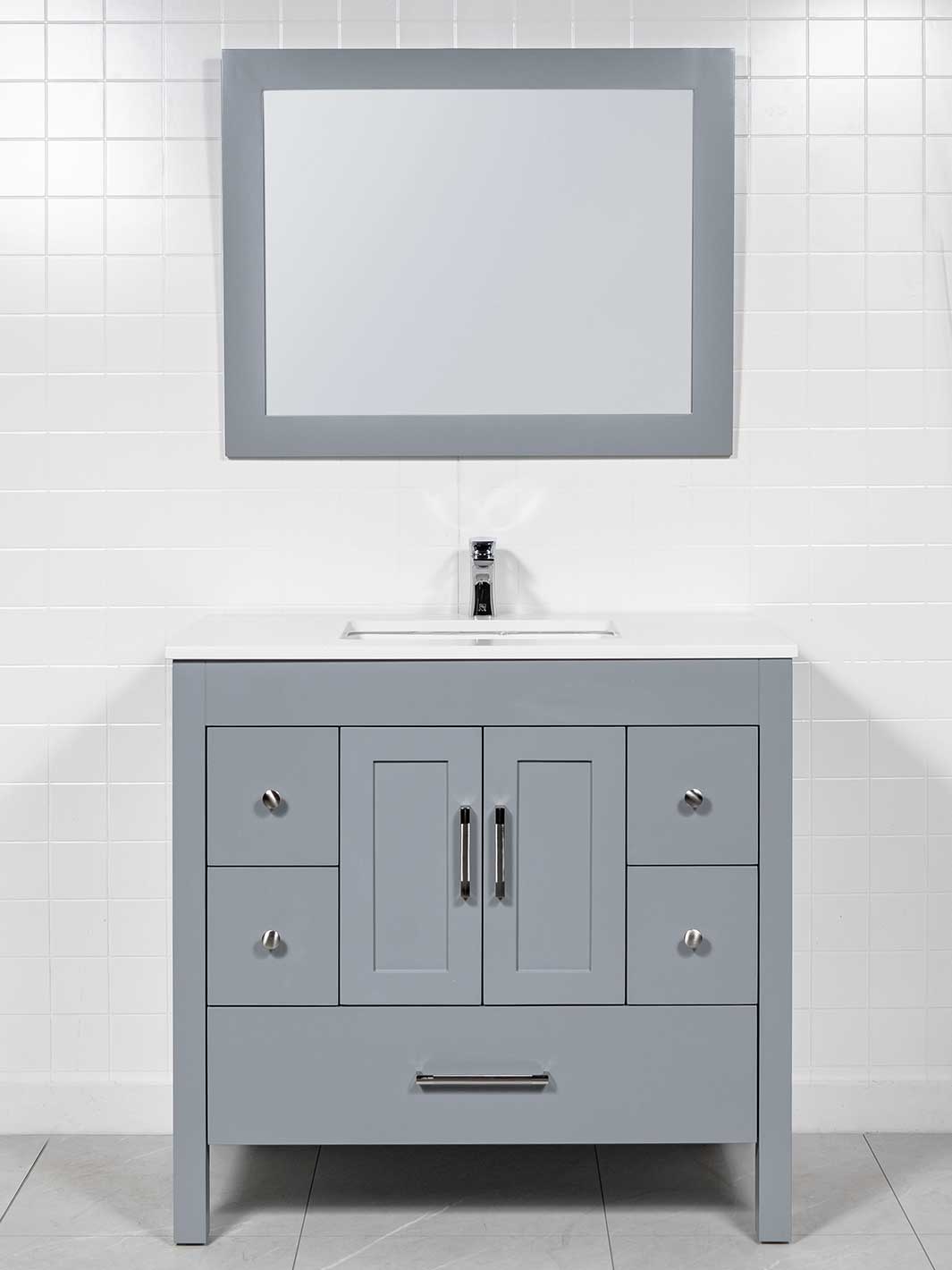 grey vaity with matching mirror, white couinter, chrome faucet and pulls