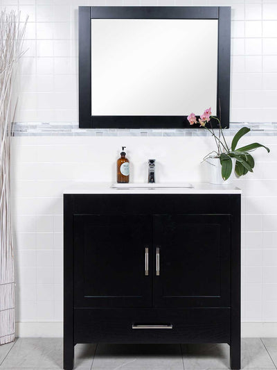 black 36 inch vanity with white counter and black framed mirror