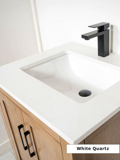white quartz counter and matte black faucet on white oak vanity