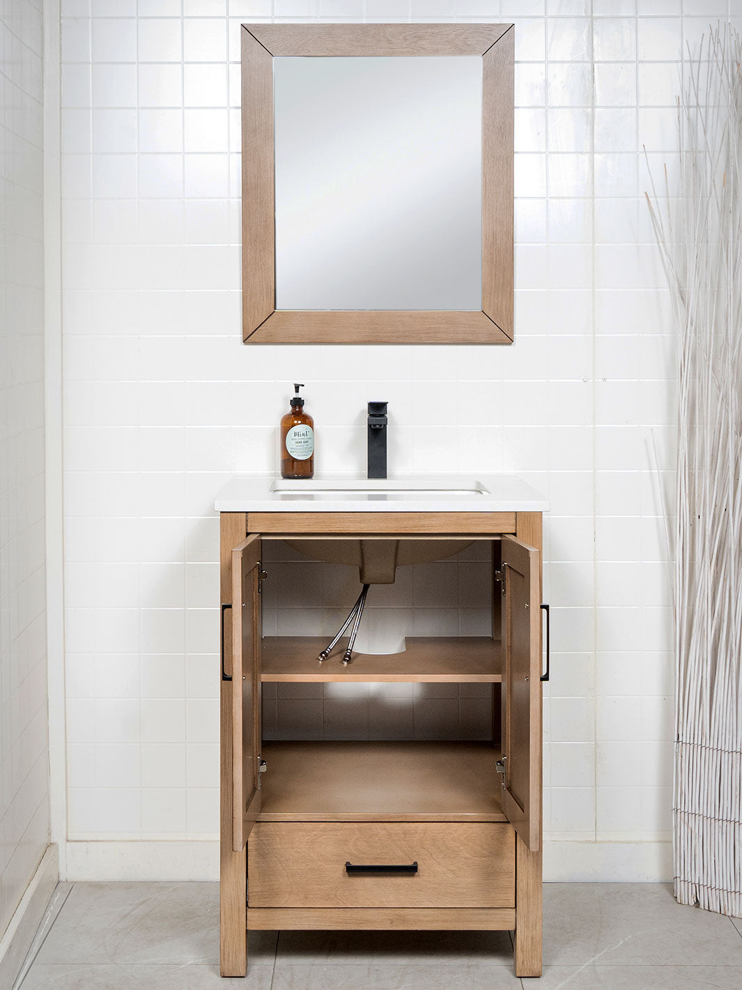 white oak vanity with matte black handles and double shelf cupboard beneath the sink 