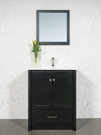 black vanity with kickboard, black framed mirror, white quartz counter, and chrome faucet