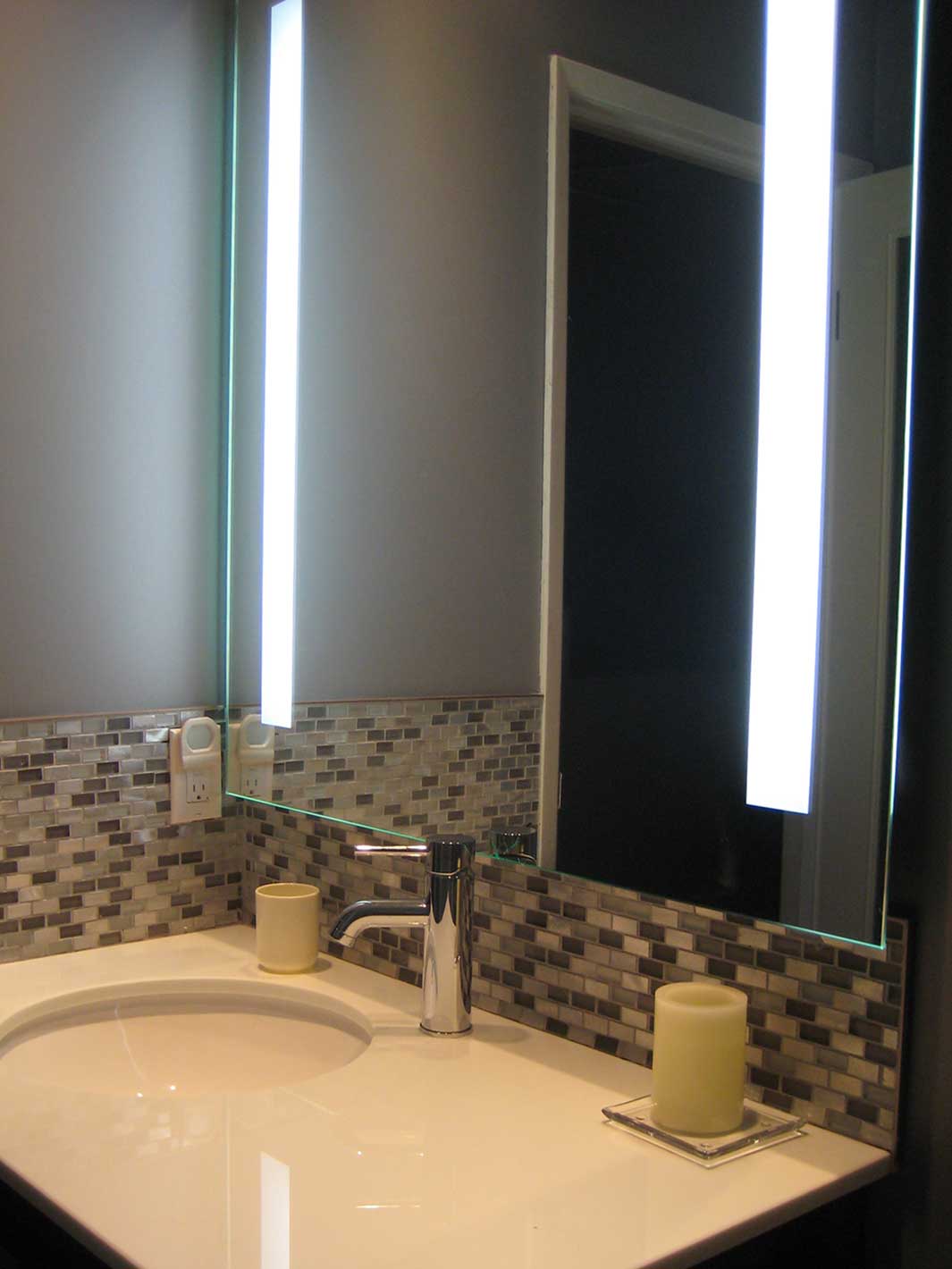 LED mirror installed over vanity