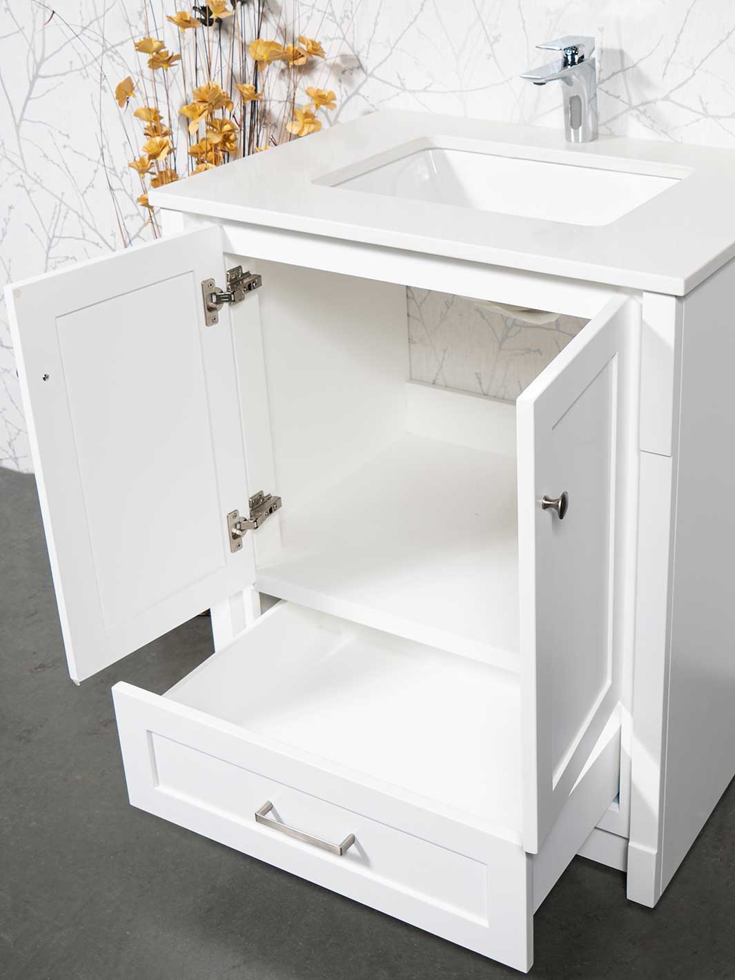 cupboard beneath sink and drawer at bottom with white quartz counter 