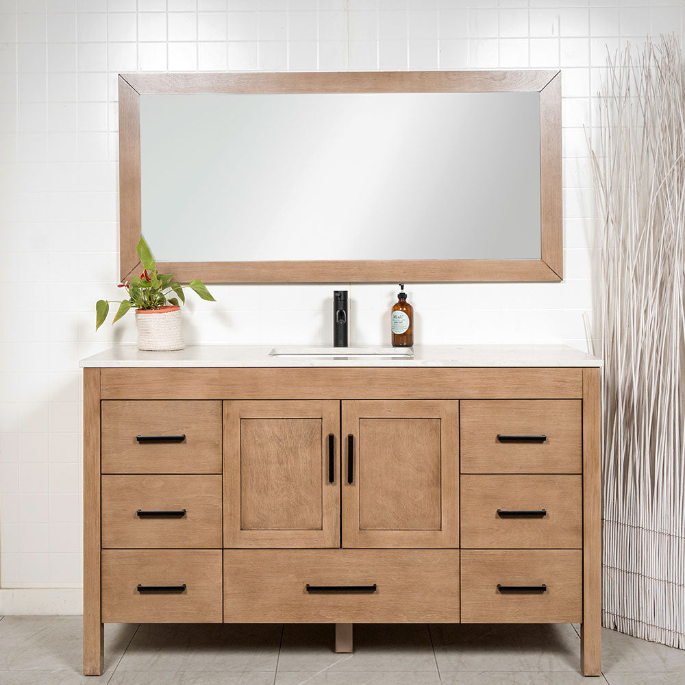 White oak bathroom vanity with white quartz counter, matching mirror and black faucet and door hardware