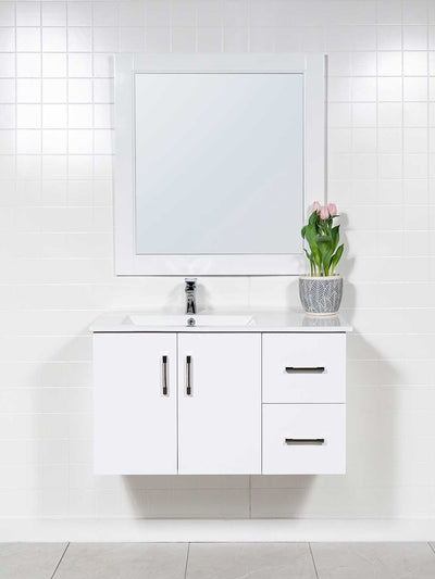 36 inch wall hung vanity in white with sink on the left side. two drawers on the right. white wood framed mirror