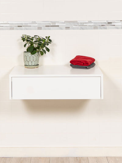 white floating makeup table with a drawer