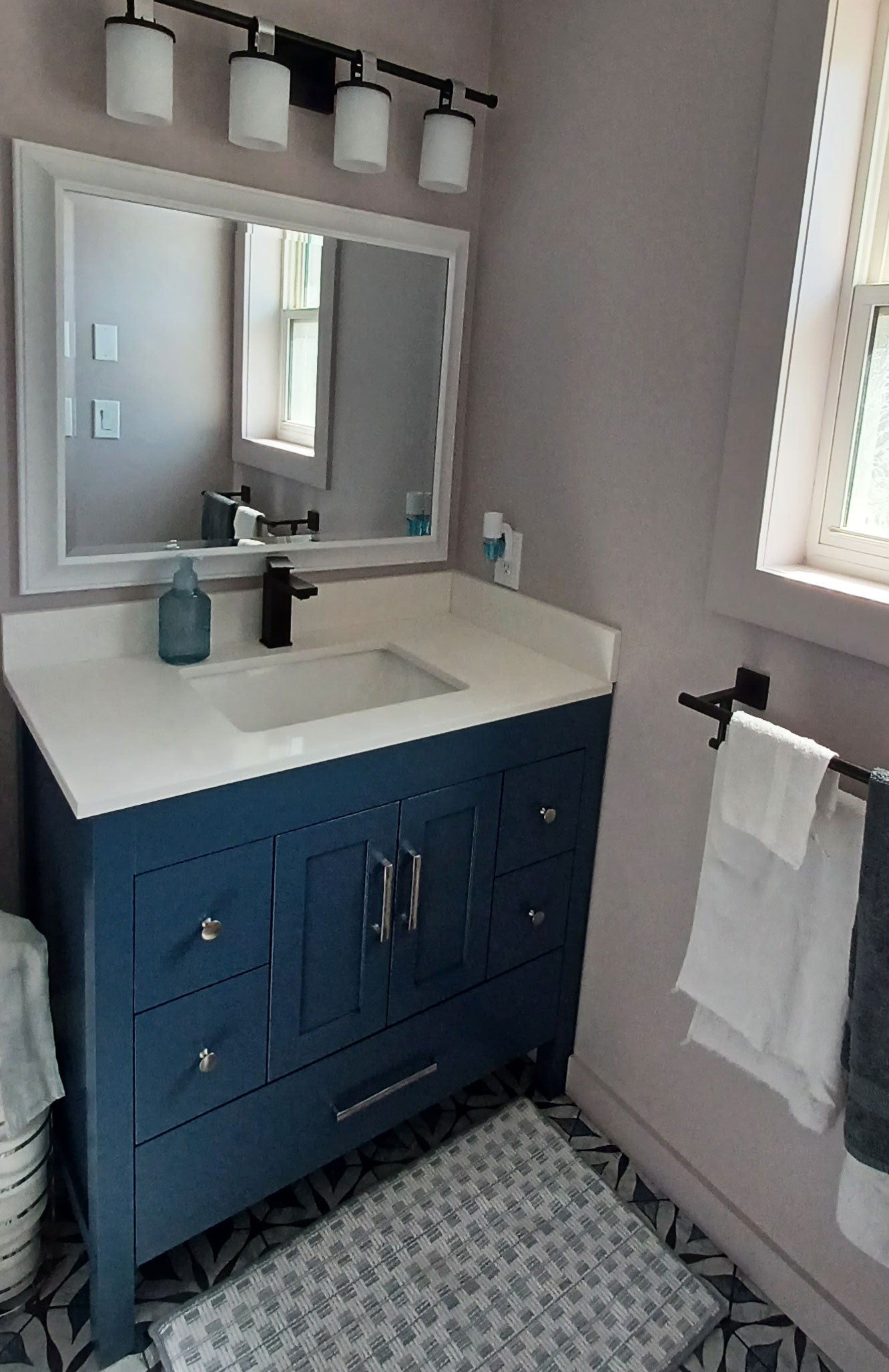 blue vanity, black faucet, white mirror