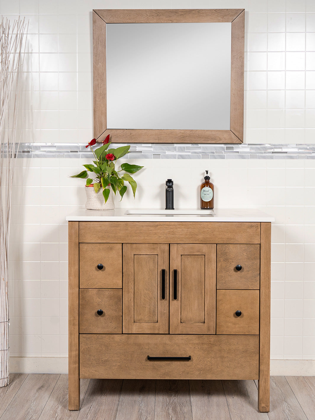 white oak vanity with matching mirror. black faucet and door pulls