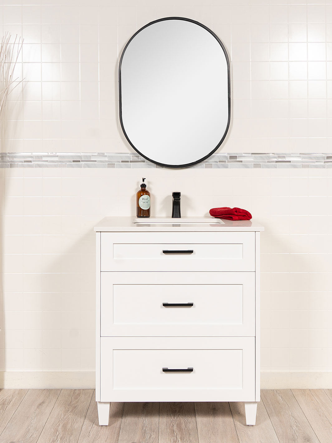 white 30 inch vanity with drawers black pulls and oval black framed mirror