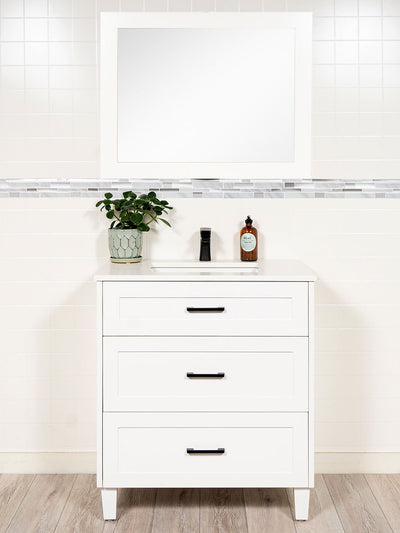 white vanity with drawers, white wood framed mirror. black pulls