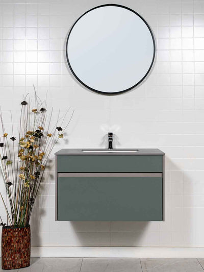 green bathroom vanity floating style with round black framed mirror, and grey sintered stone countertop