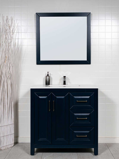 Blue vanity with 3 drawers on the right. White counter. black framed mirror