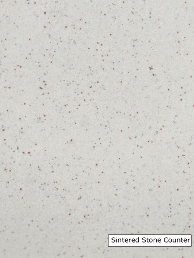 Sintered stone with small reddish and grey flecks on a beige background
