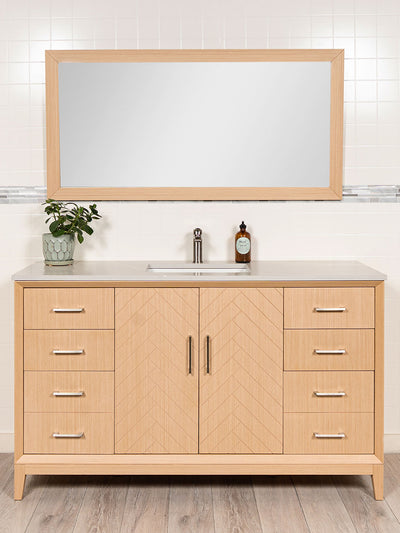 Light oak vanity with herringbone design, brushed nickel pulls, matching wood framedmirror