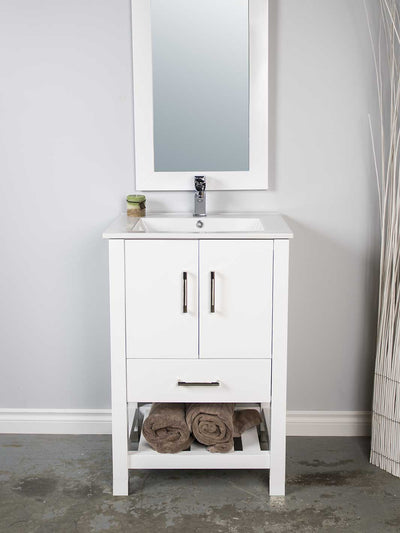 white vanity with open bottom shelf, white framed mirror, white ceramic sink, and chrome faucet