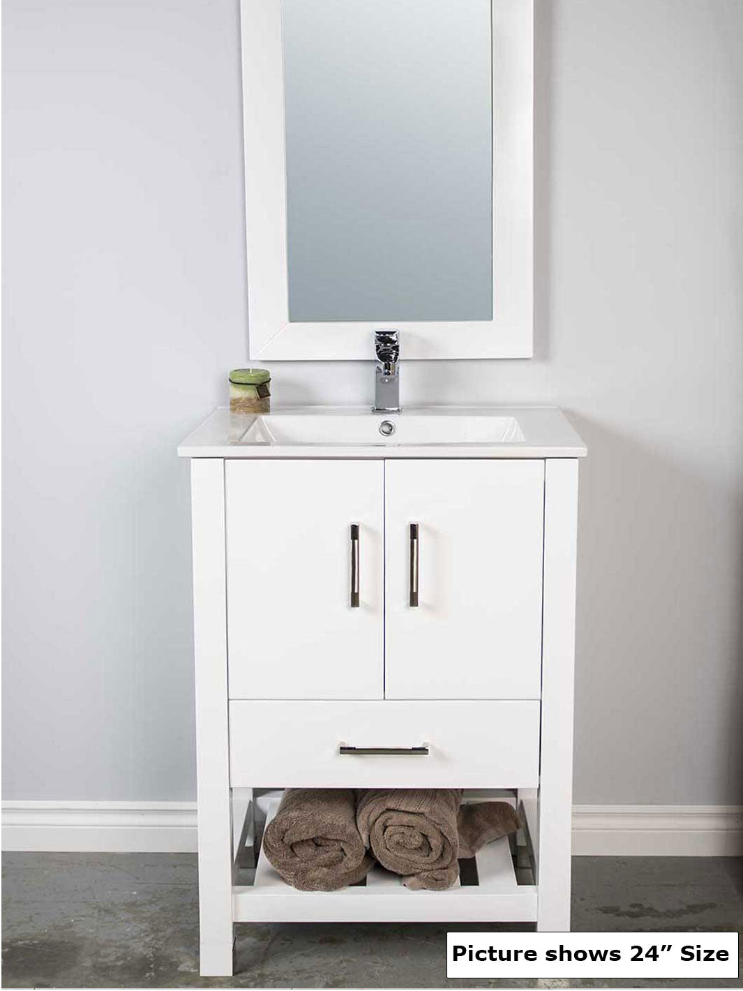 White vanity with open bottom shelf. White sink. White wood framed mirror