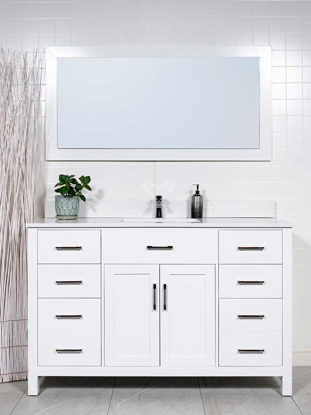 White bathroom vanity with sink and wood framed mirror