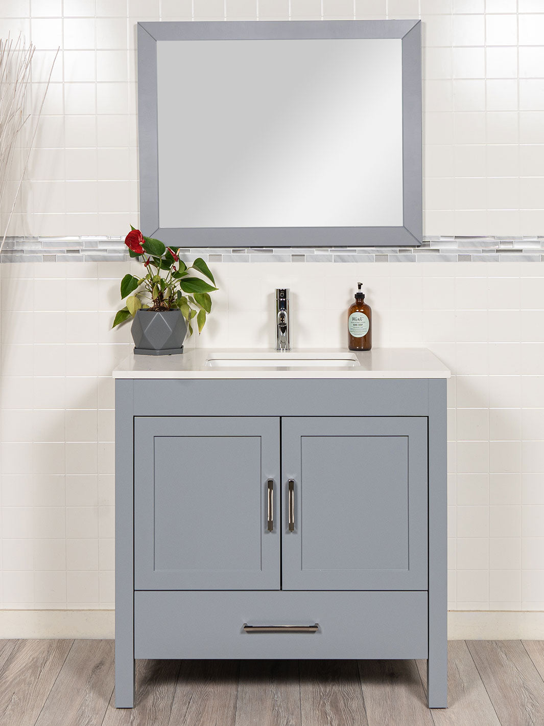 grey bathroom vanity with matching grey mirror. white quartz counter. chrome faucet