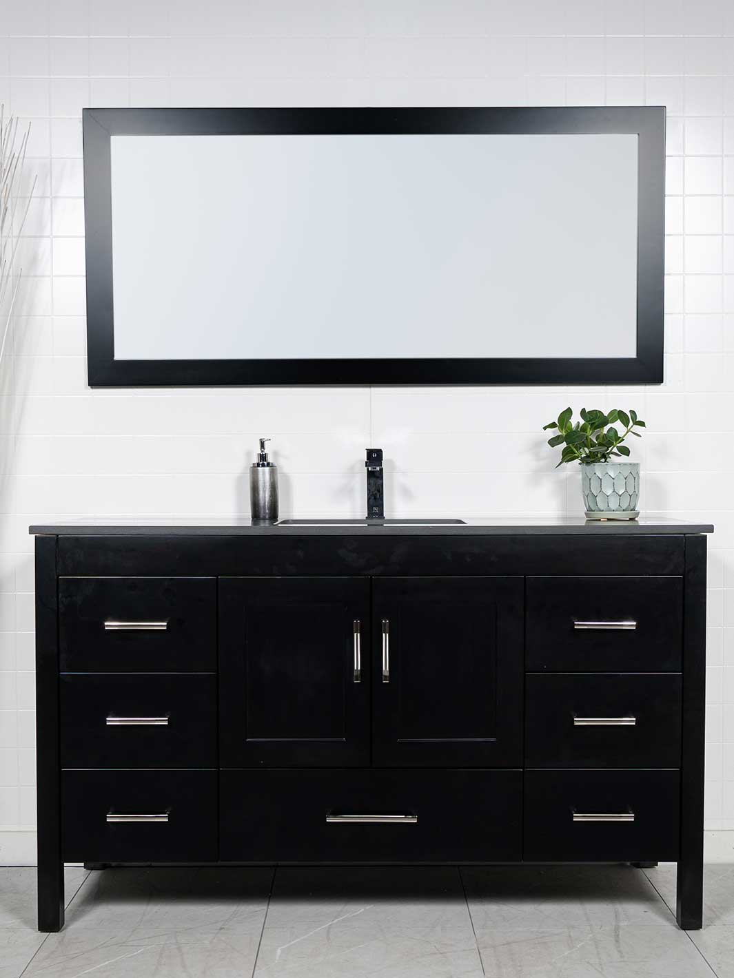 black bathroom vanity with grey quartz counter, black framed mirror