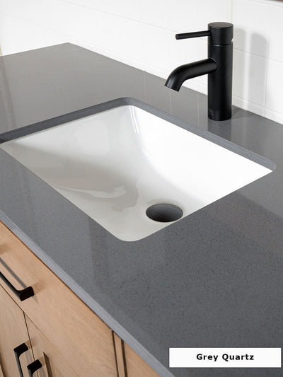grey quartz counter with attached undermount sink and matte black faucet