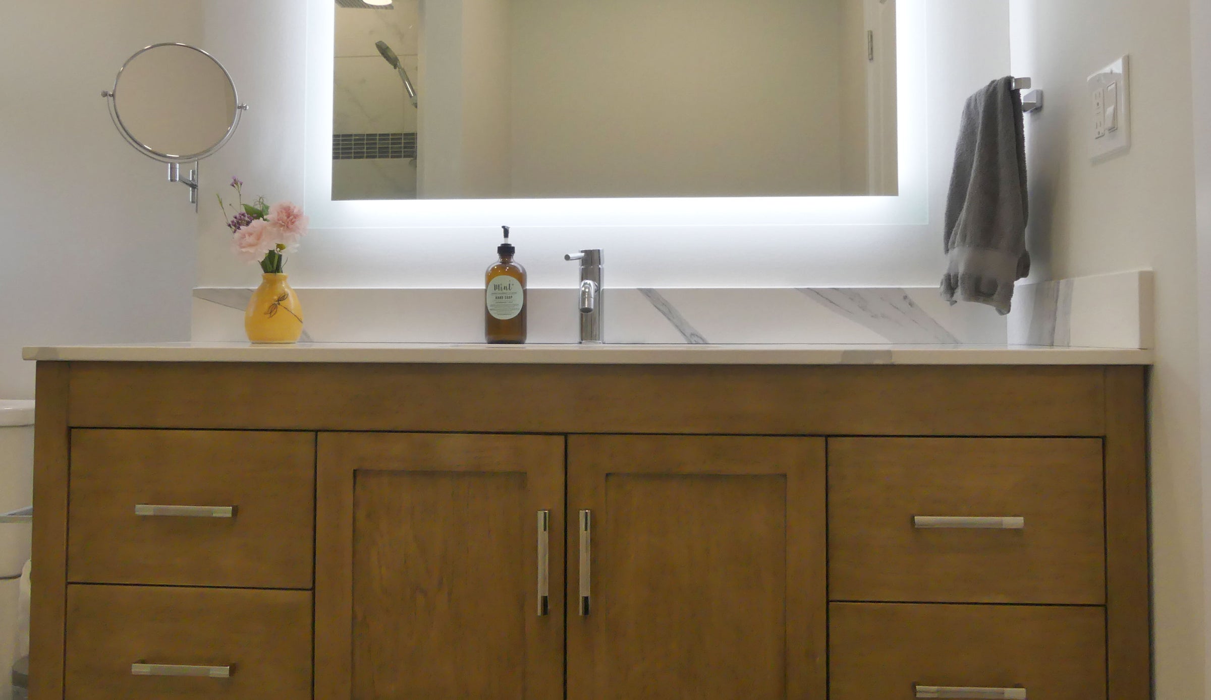 white oak single sink vanity, backlit mirror