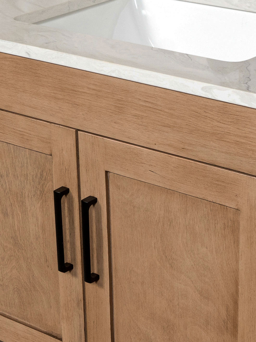 Black door pulls on the white oak cabinet