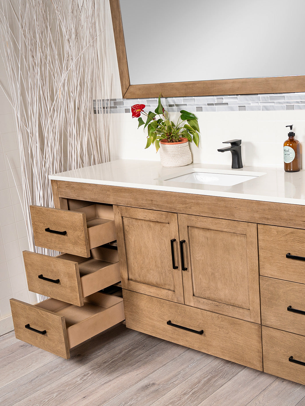 3 side drawers open, white oak vanity, black pulls and faucet