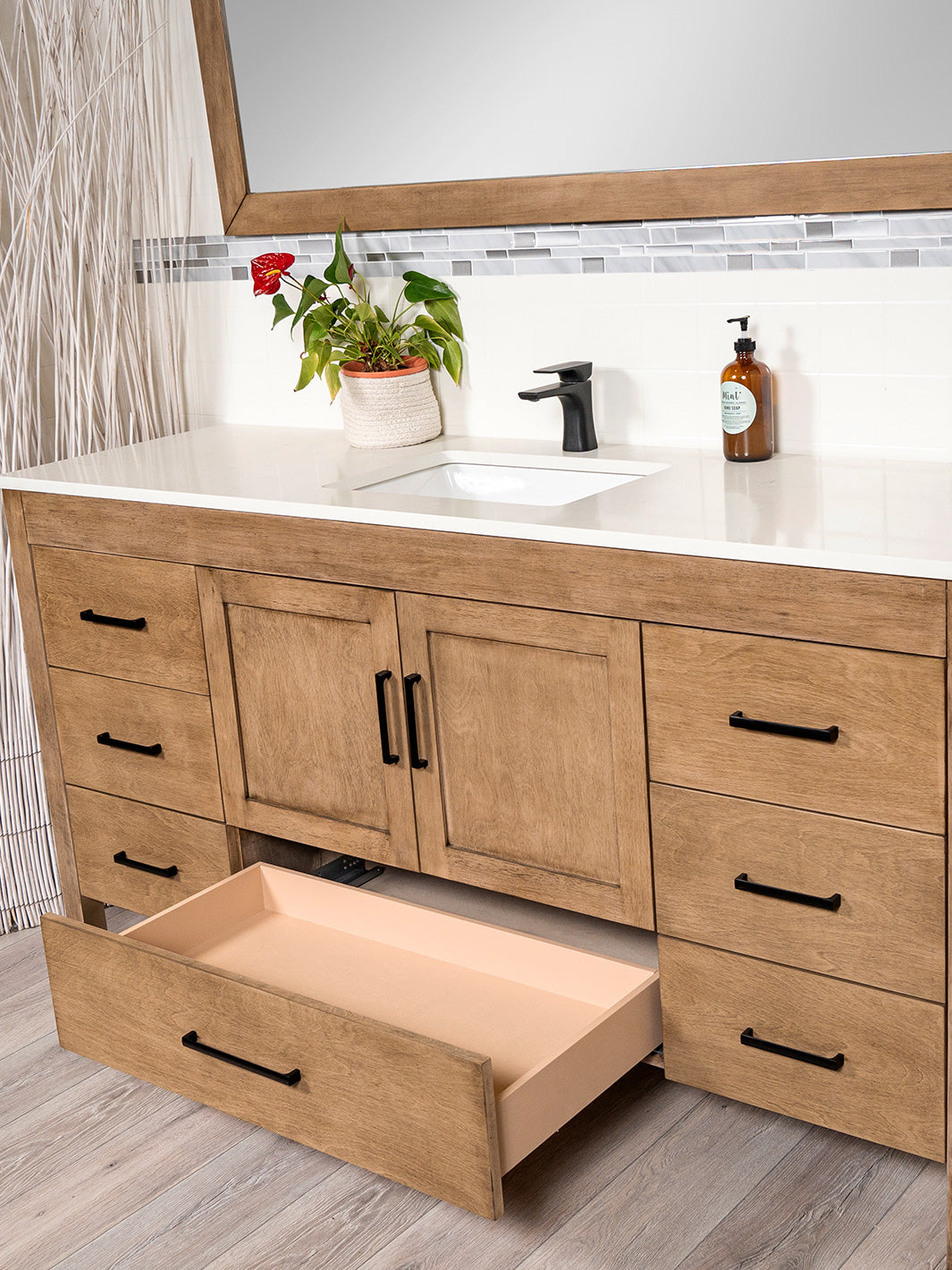 bottom drawer open for white oak vanity. white quartz counter