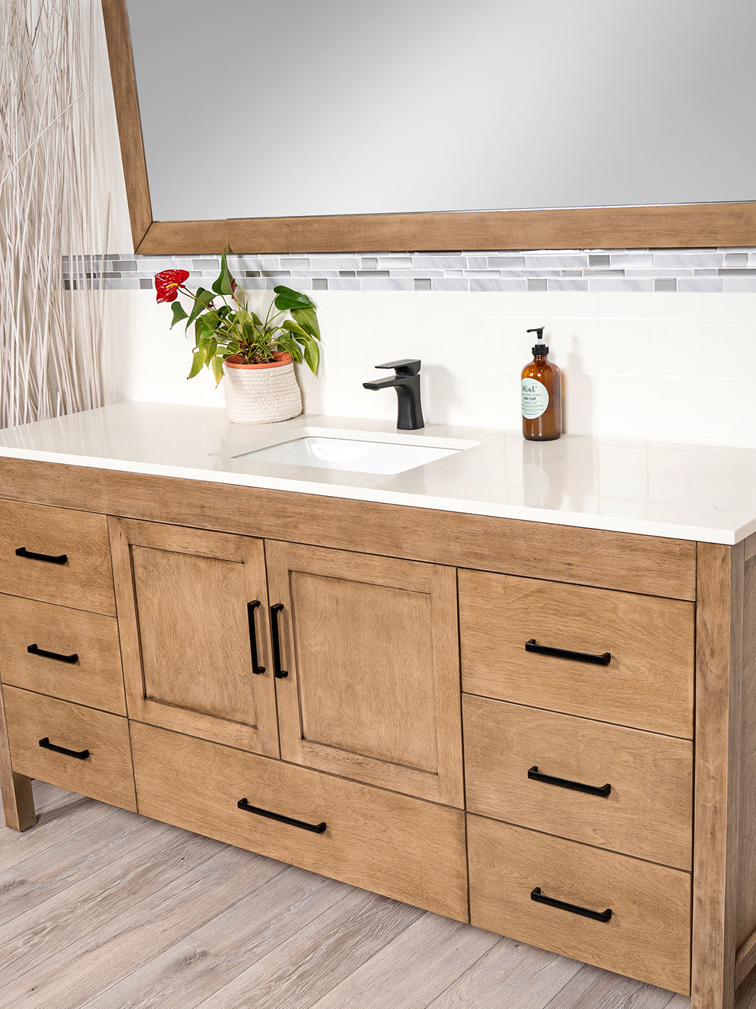 white quarz counter on white oak vanity, black pulls and faucet