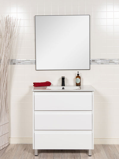 vanity with drawers in white. black faucet and black framed mirror