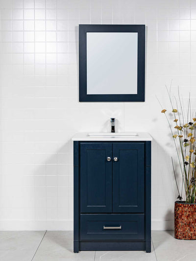 blue vanity with kickboard, blue framed mirror, white quartz counter, and chrome faucet