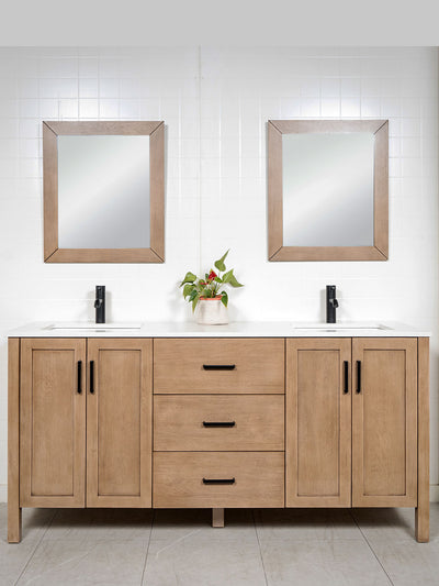 white oak double vanity with black faucets and black door pulls. matching wood framed mirrors