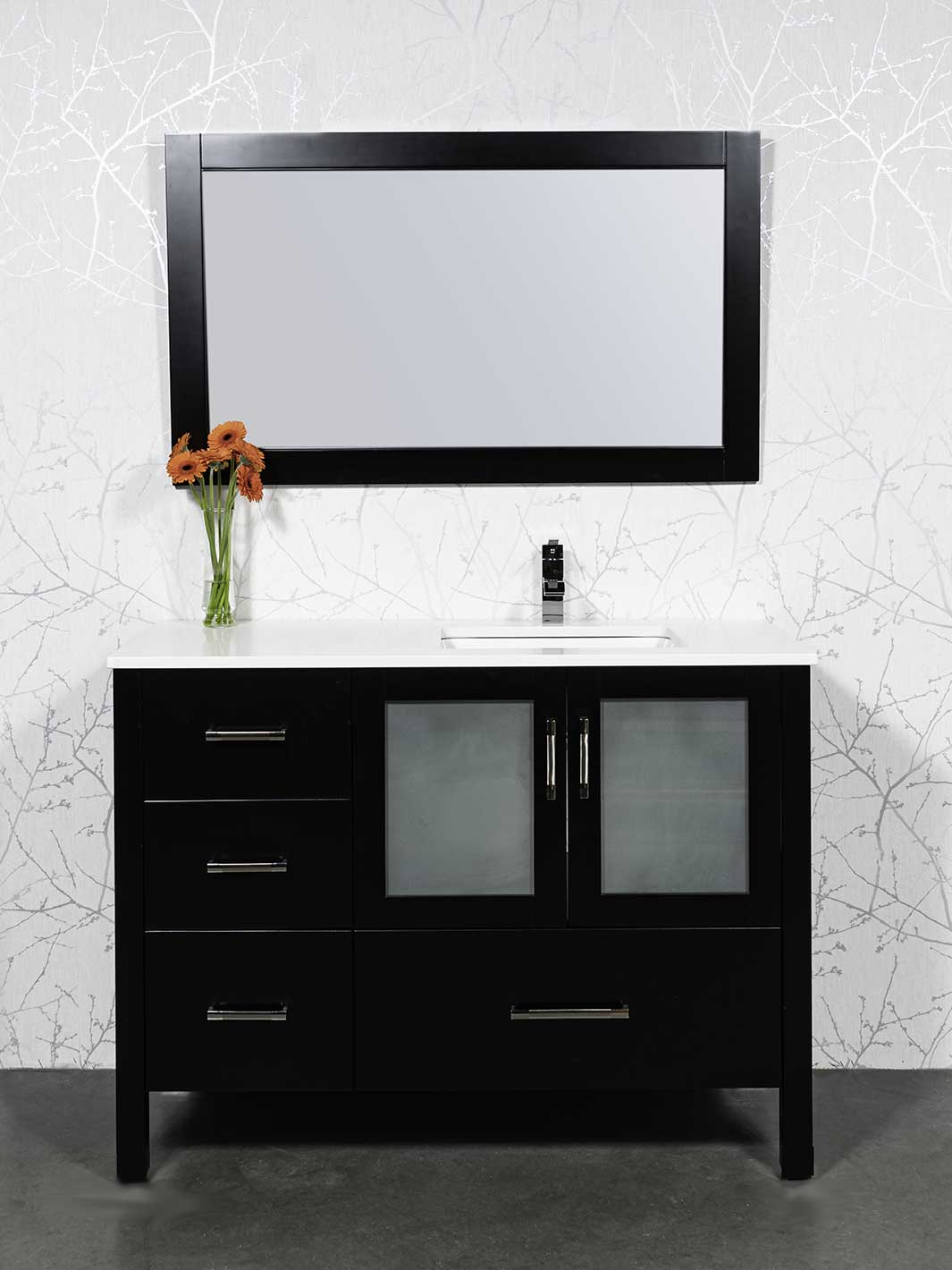 black vanity with sink offset on right.  mirror and counter shown