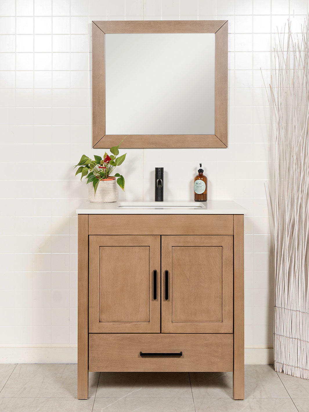white oak bathroom vanity with matching mirror, black door pulls and black faucet